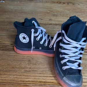 Converse Black High-Tops with Vibrant Orange Soles